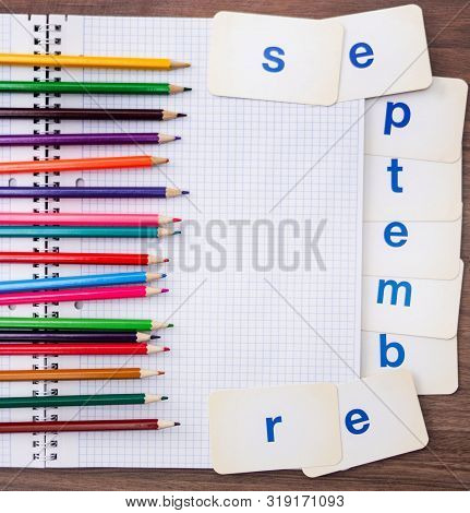 September Colored Pencils On An Open Squared Notebook