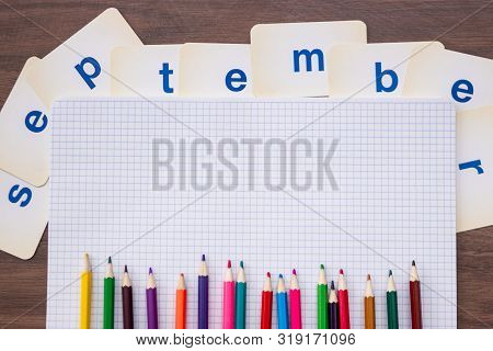 September Colored Pencils On An Open Squared Notebook