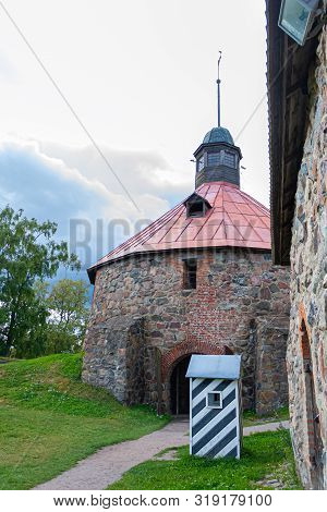 Watchtower Of The Karela Fortress With A Guard Booth And The Main Gate Against A Stormy Sky In Summe