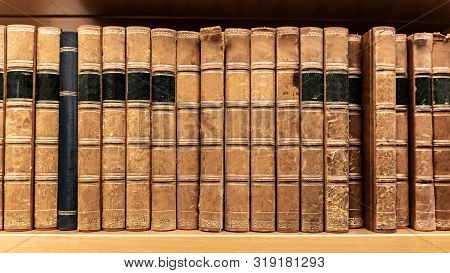 Antique Leather Cover Books On Wooden Bookshelf In University Public Library. Reading Philosophy Or 
