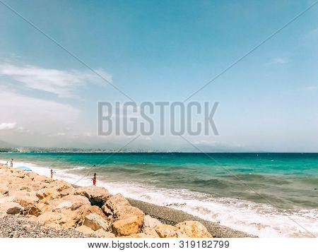 Rocky Sea Shore With Splaches Of Waves. Mediterranean Sea Coast. Seascape. Beautiful Day, Blue Sky, 