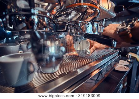 Diligent Barista Is Prepairing Fresh Latte For Customers For Coffee Break At Caffeteria.