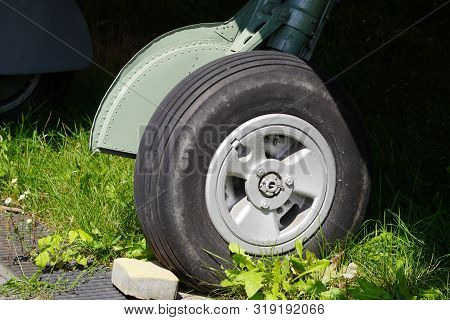 Aircraft Chassis Landing Gear Wheel. Close-up High Detailed View On Main Landing Gear Of Old Airplan