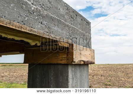 Reinforced Concrete Slab In The Shape Of A Rectangle On Concrete Poles. Visible Formwork And Buildin