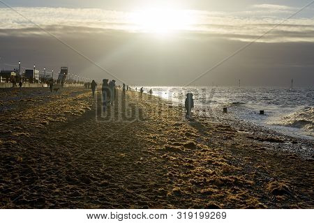 Hunstanton, Norfolk, England, Uk - January 1, 2019: Foggy Winter Day In Hunstanton Beach, People Lok
