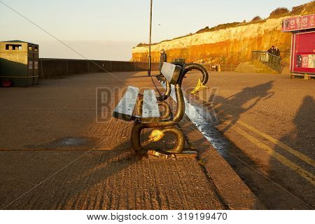 Hunstanton, Norfolk, England, Uk - January 1, 2019: Lonely Bench In Foggy Winter Evening In Hunstant