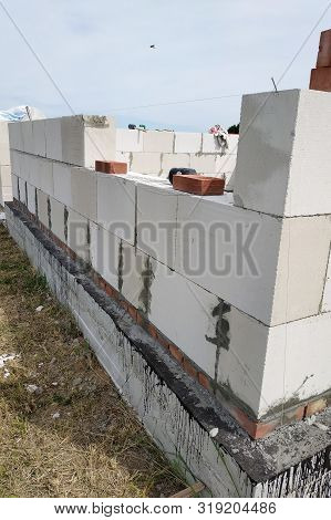 Laying The Wall Of Gas Blocks With Tools And Glue.