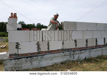 Laying The Wall Of Gas Blocks With Tools And Glue.