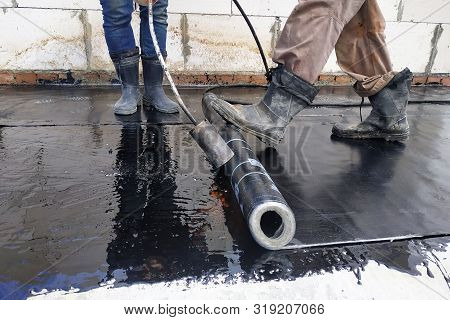 The Workers Cover The Concrete Screed With Bituminous Liquid Solution And Stele The Waterproofing.