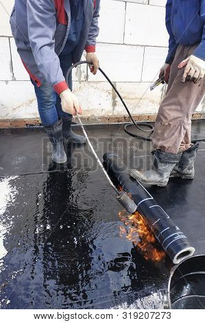 The Master Works With The Assistant To Work On The Waterproofing Of The Surface.