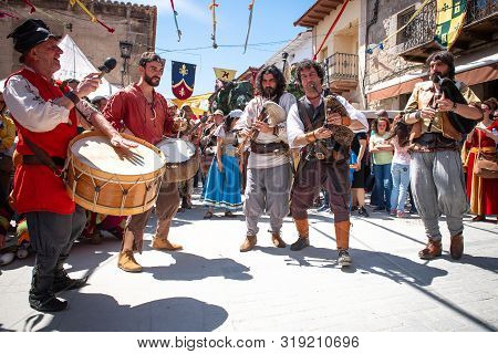Buffoon Acting Surrounded By People Mimetricated With The Event.