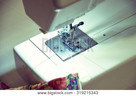 The Process Of Processing Fabric On A Sewing Machine Closeup