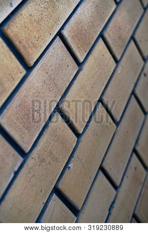 Brick Wall Of Beige Pink Color, Diagonal Perspective, Fragment With Blue Gray Cement In The Seam, Sp
