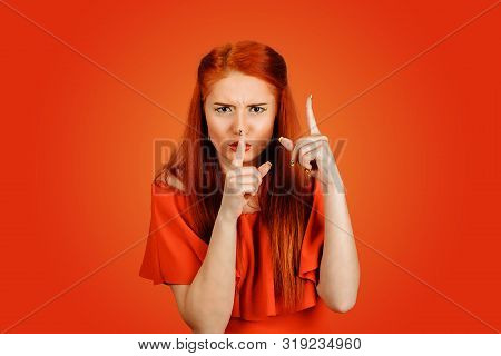 Shh. Angry Woman Showing Shh, Silence, Hush Sign Gesture With One Hand And Attention Listen To Me Wi