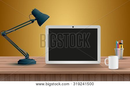 White Tablet And Lamp On The Wooden Table