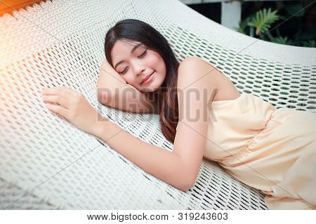 Young And Cute Asian Women Sleeping In A Hammock During Holiday