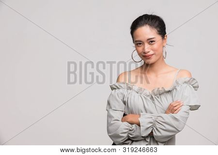 Beautiful Asian Woman In Grey Shirt Standing And Is Posing Wai, It Is The Thai Traditional, Isolated