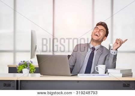 Handsome Caucasian Businessman Laughing By Happy Mood In Modern Office.