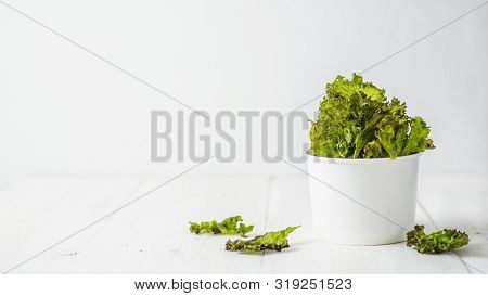 Kale Chips With Salt In Paper Cup. Homemade Healthy Snack For Low Carb, Keto, Low Calorie Diet. Whit