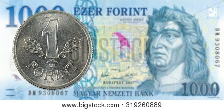 1 Hungarian Forint Coin Against A New 1000 Hungarian Forint Banknote Indicating Growing Economics Wi
