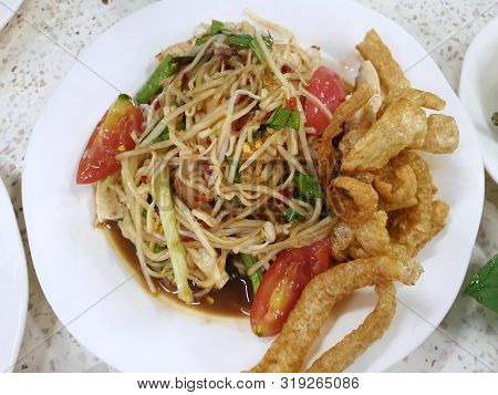 Thai Food Style, Top View Of Papaya Salad And Pork Crackling In Restaurant, This Food Is Most Popula
