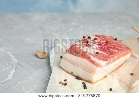 Pork Fatback And Pepper On Grey Stone Table. Space For Text