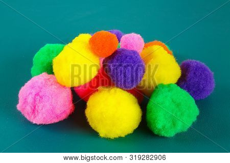 Colored Beautiful Pompons On A Teal Background. Assortment Of Pompons. Diy Craft.