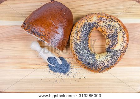 Raw Blue Poppy Seeds In The Special Wooden Spice Spoon, Pie With Crushed Poppy Seed Filling And Big 
