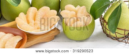 Fresh Peeled Pomelo, Grapefruit, Shaddock With Green Leaf On Bright Wooden Plank Table. Seasonal Fru