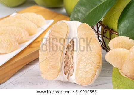 Fresh Peeled Pomelo, Grapefruit, Shaddock With Green Leaf On Bright Wooden Plank Table. Seasonal Fru
