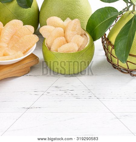 Fresh Peeled Pomelo, Grapefruit, Shaddock With Green Leaf On Bright Wooden Plank Table. Seasonal Fru