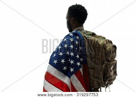 Back View Of Male Ranker With Backpack Holding American Flag On One Shoulder And Looking Away. Young