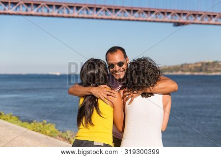 Happy Friends Meeting Outdoors And Greeting Each Pother. Excited Man And Women Standing Near River, 