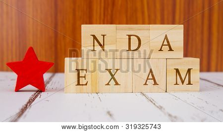 Concept Of Nda Exam Conducted In India For Recruitment On Wooden Block Letters.