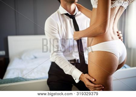 Passionate Beautiful Couple In Bedroom Enjoying Foreplay