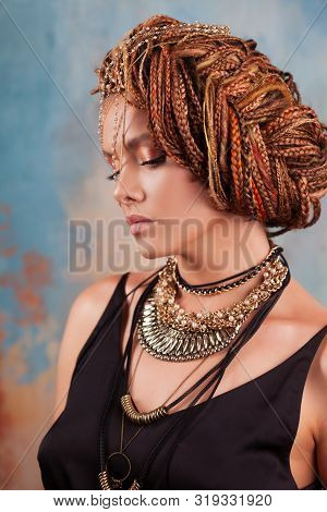 Southern Flavor. Portrait Of A Luxurious Tanned Woman, Pensive, Stylish, With An Exotic Hairstyle An