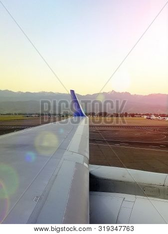 ..beautiful View From The Window Of The Plane To The Mountains. View From The Aircraft's Illuminator