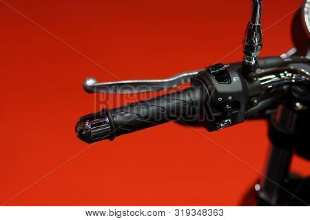 Motorcycle Handle Bar. Close Up Of Motorcycle Left Handle Bar On Red Background;