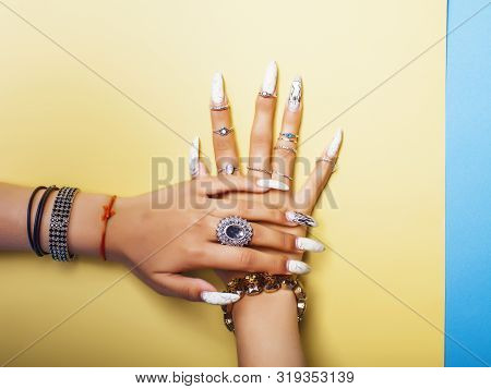 Woman Hands Holding Colorful Paper Copyspace Wearing A Lot Of Jewelry And Long Nails Closeup