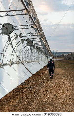 Logrosan, Extremadura, Spain - March 23, 2019: Worker Checking The Concentrators And Solar Panels Of