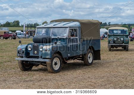 Haselbury Plucknett.somerset.united Kingdom.august 18th 2019.a Vintage Land Rover Is Being Driven At