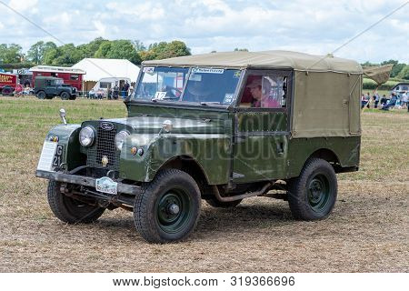 Haselbury Plucknett.somerset.united Kingdom.august 18th 2019.a Vintage Land Rover Is Being Driven At