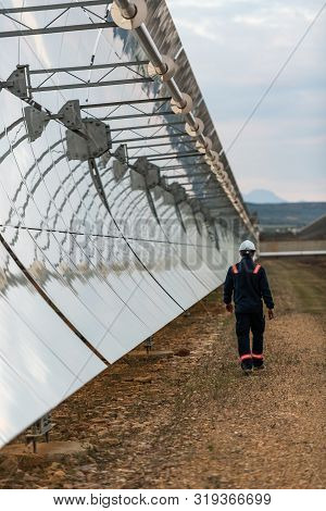 Logrosan, Extremadura, Spain - March 23, 2019: Worker Checking The Concentrators And Solar Panels Of