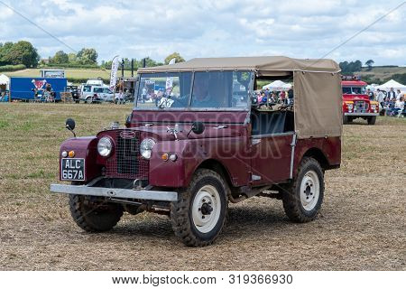 Haselbury Plucknett.somerset.united Kingdom.august 18th 2019.a Vintage Land Rover Is Being Driven At