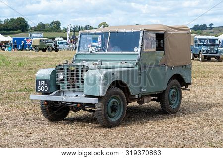 Haselbury Plucknett.somerset.united Kingdom.august 18th 2019.a Vintage Land Rover Is Being Driven At