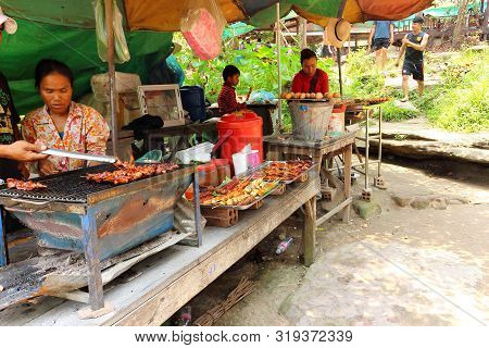 Siem Reap, Cambodia- Mart 25, 2018: Unhurried Cambodian Life. Cooking Local Cuisine On Grill And Bar