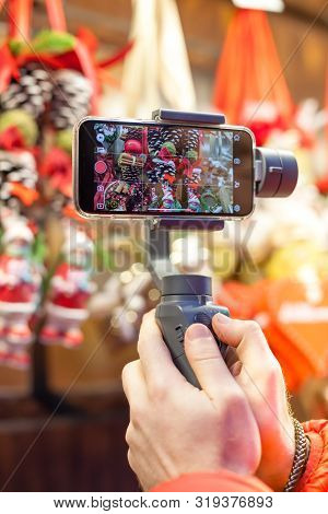 Germany, Munich - December 20, 2018: Close-up Of Man Blogger Hands Shooting Video On Smartphone Ipho