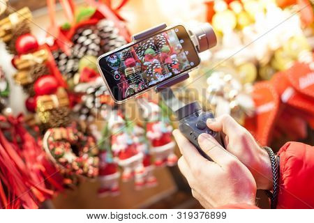 Germany, Munich - December 20, 2018: Close-up Of Man Blogger Hands Shooting Video On Smartphone Ipho