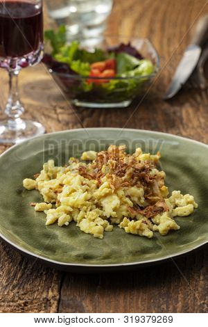 Homemade Swabian Pasta Dish On Wood With Salad