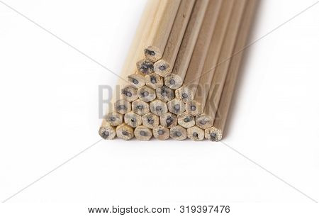 Pyramid Of Wooden Unsharpened Pencils On A White Background